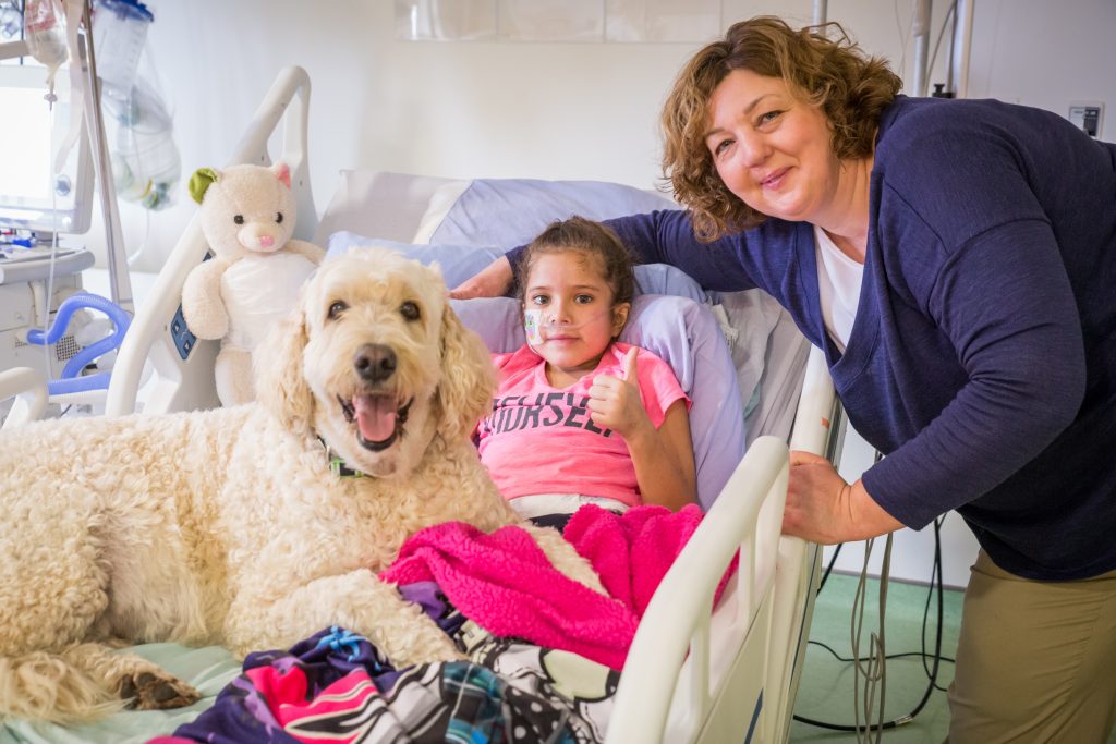 Tanika Jacobs and nurse, Shelley Farrell, share a cuddle with Lukus 