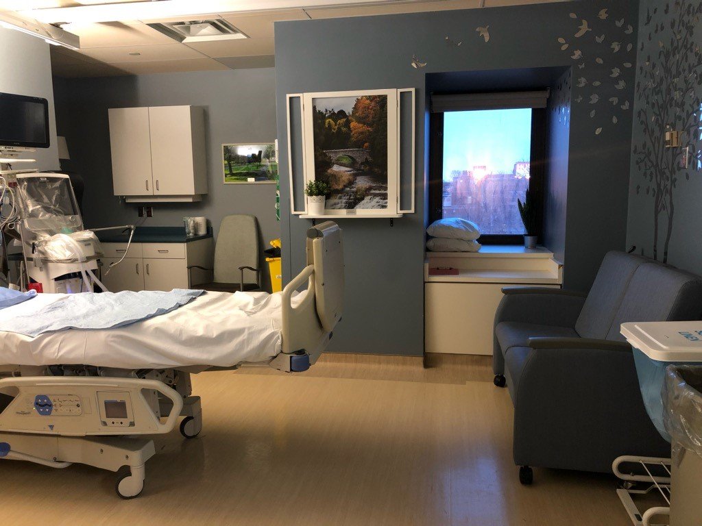 a hospital room with blue walls and calming decor