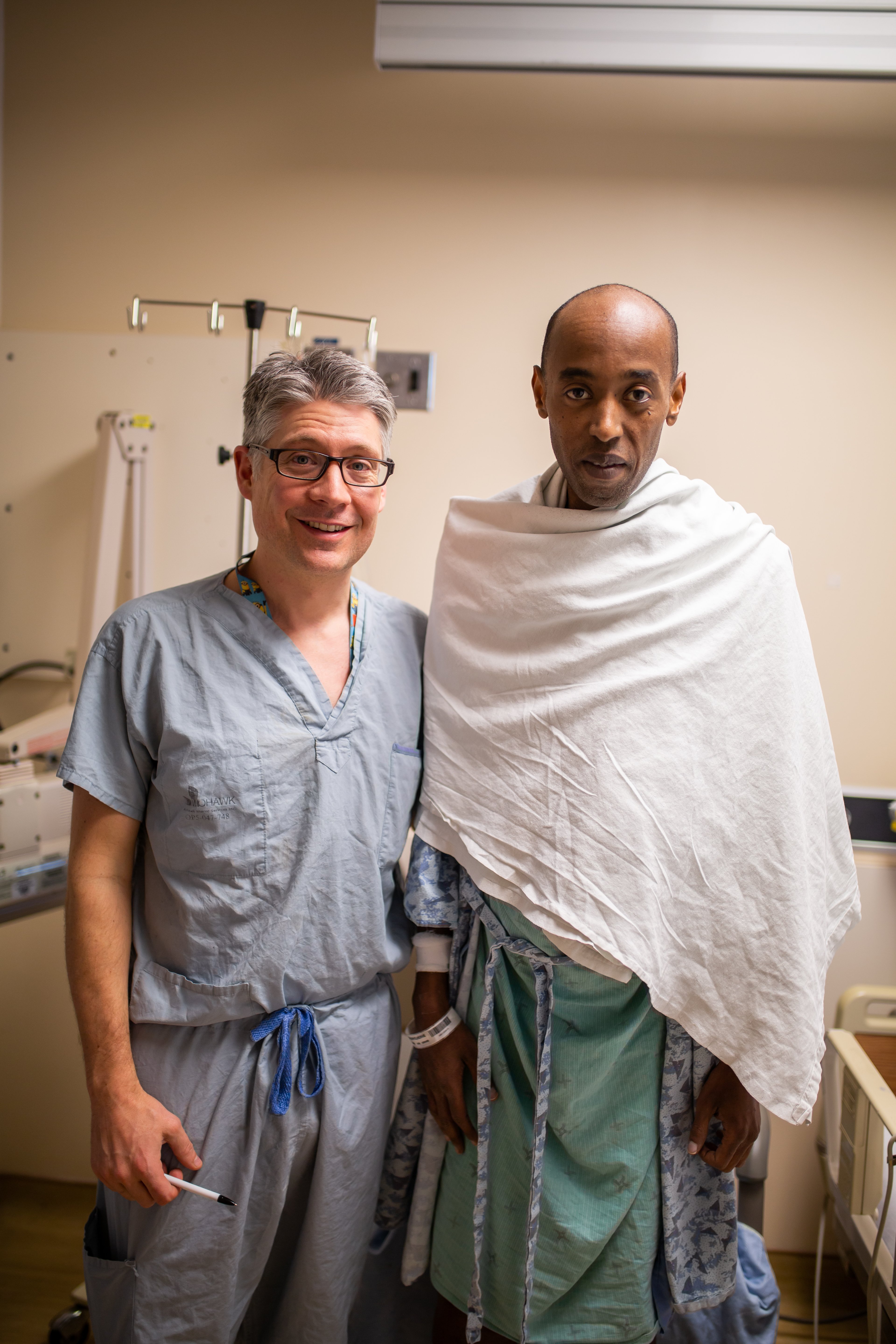 Dr. Whitlock and Herve stand together in the hospital