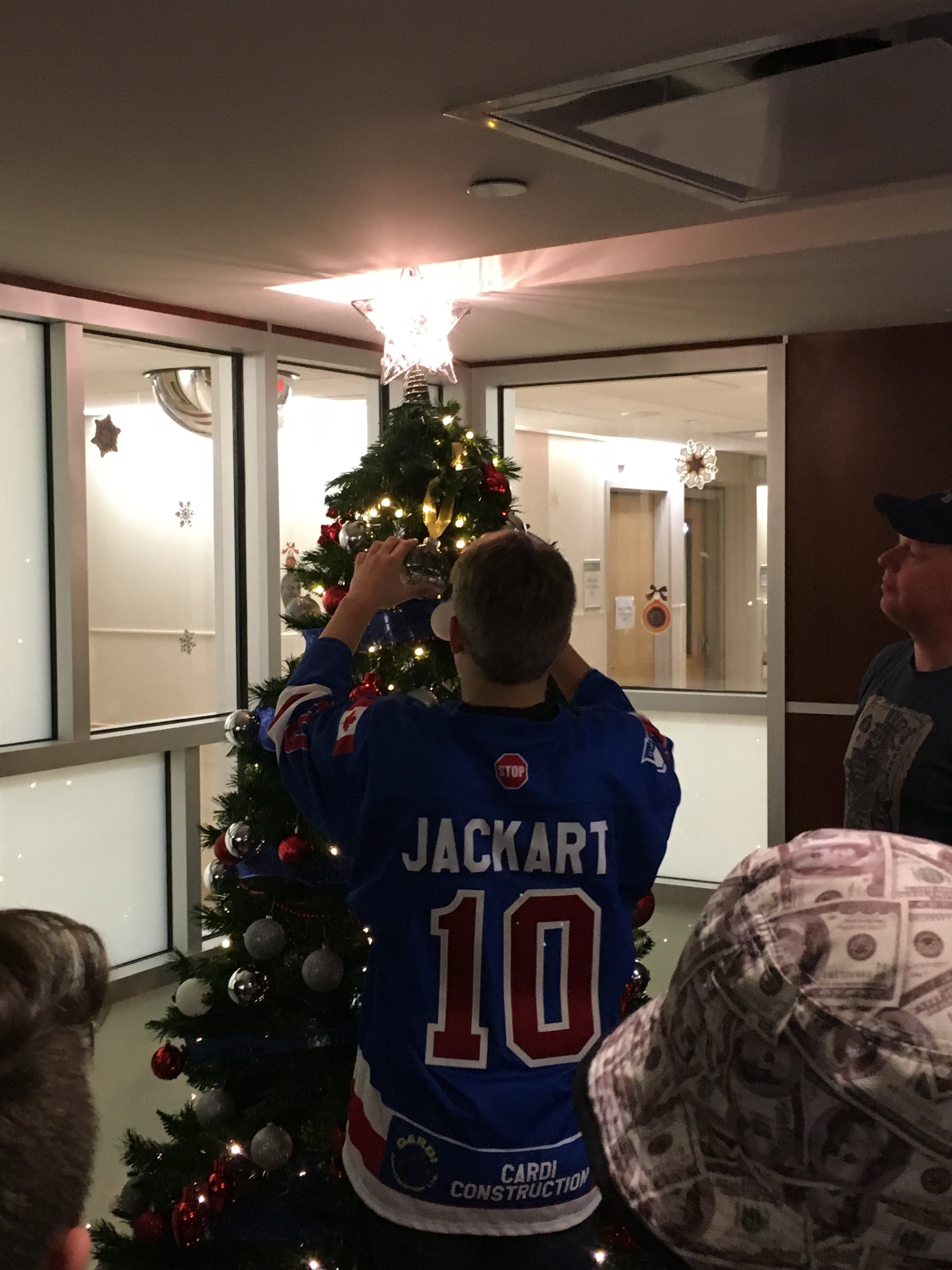 Steven places an ornament on the tree in honour of his dad, Steve Jackart