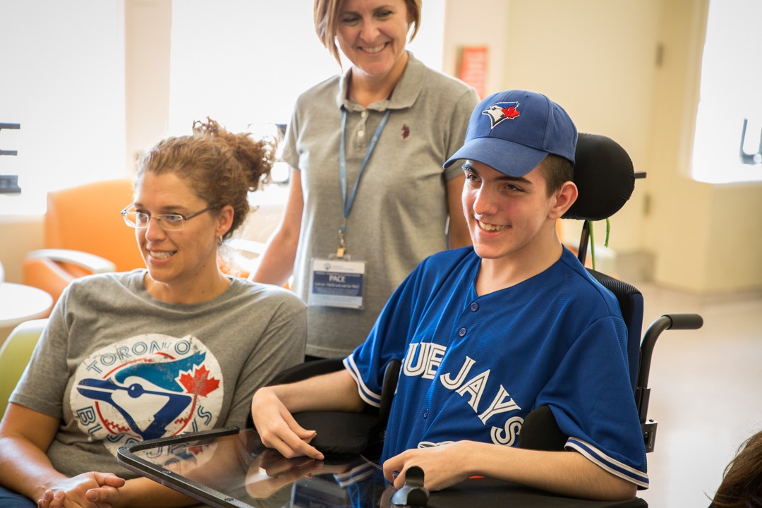 Tyler watches the Toronto Blue Jays with some of the people who cared for him