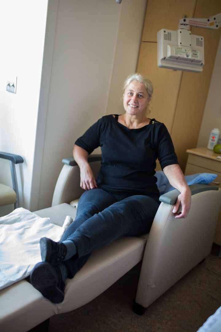 Judy Marchalewicz sits in a sleeper chair at her brother's bedside
