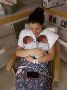 Mom holds healthy newborn Monoamniotic Monochorionic twins
