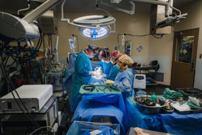 Photo of surgeons, operating on a patient