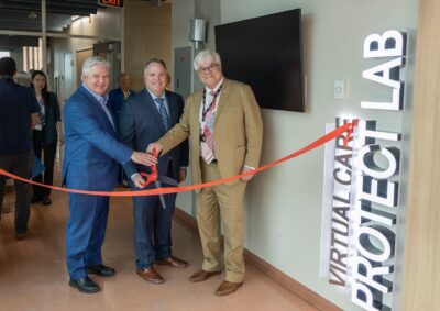 Drs. Devereaux, McGillion and Levine cutting a ribbon across the entrance to the Protect Lab