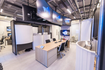 Interior photo of desks and a large screen at the HHS PROTECT Lab